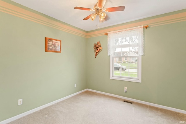 carpeted spare room featuring ceiling fan