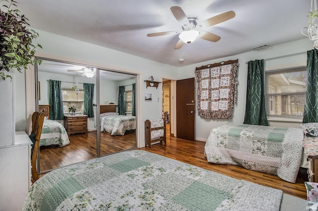 bedroom with ceiling fan, wood-type flooring, and a closet