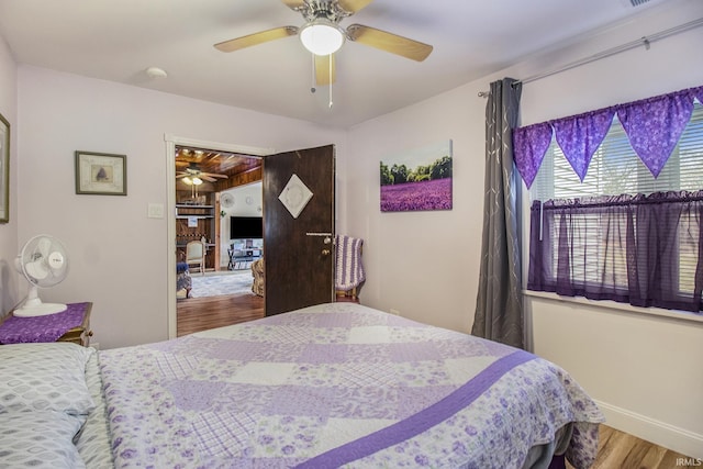 bedroom with ceiling fan and hardwood / wood-style floors