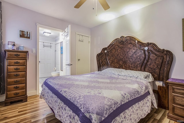 bedroom with a closet, ensuite bathroom, ceiling fan, and light hardwood / wood-style floors