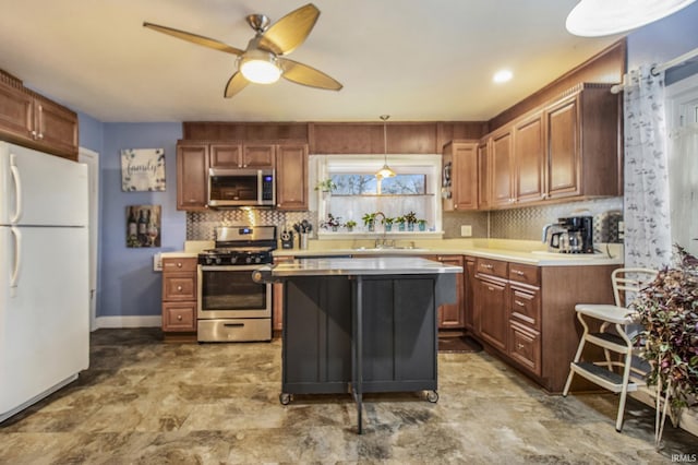 kitchen featuring ceiling fan, sink, a center island, pendant lighting, and appliances with stainless steel finishes