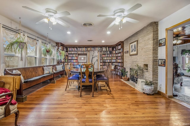 dining room with ceiling fan and light hardwood / wood-style flooring