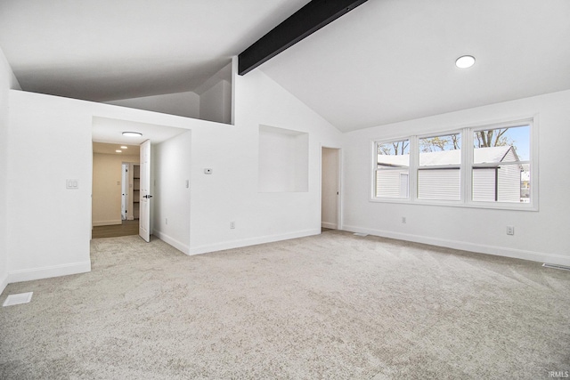 carpeted spare room with lofted ceiling with beams