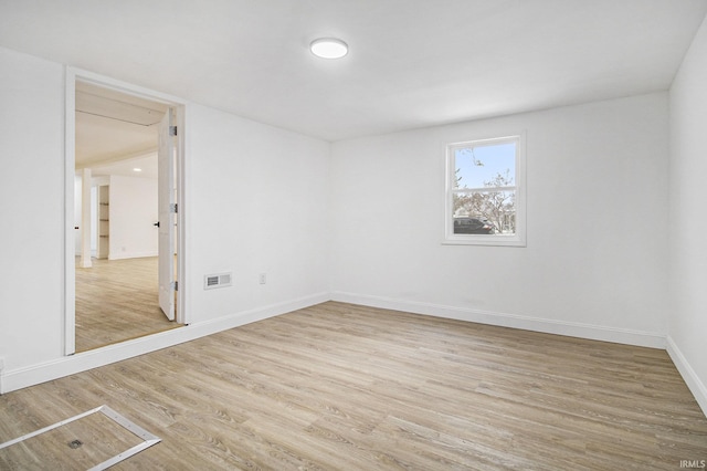 spare room featuring light wood-type flooring