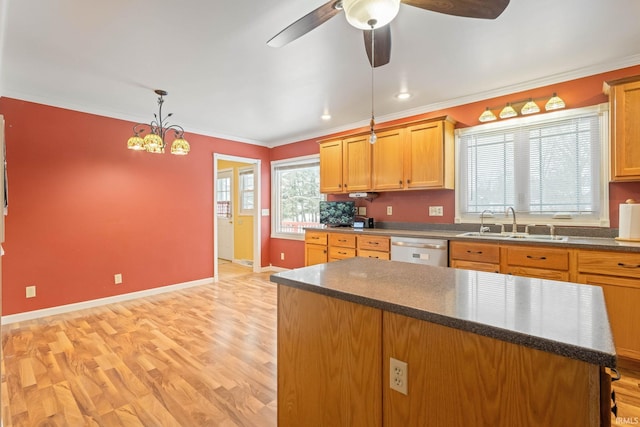 kitchen with sink, stainless steel dishwasher, ornamental molding, decorative light fixtures, and light hardwood / wood-style floors