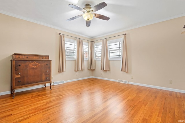 spare room featuring ceiling fan, light wood-type flooring, and crown molding