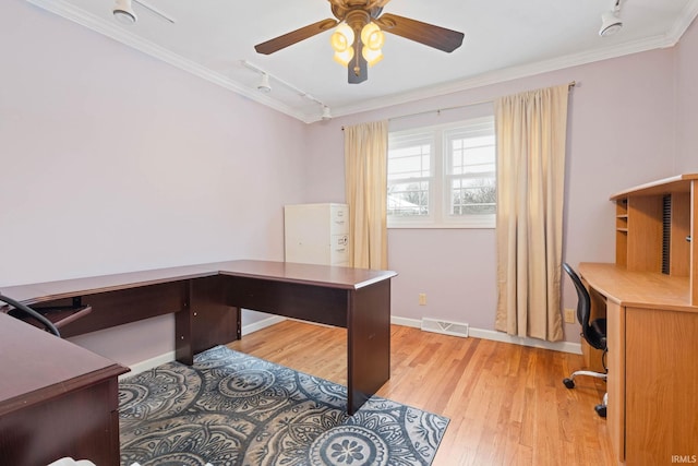 office with light hardwood / wood-style flooring, rail lighting, and ornamental molding