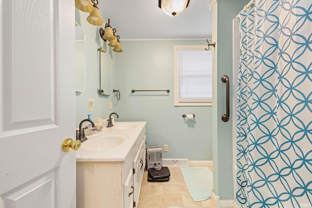 bathroom with tile patterned floors, vanity, ornamental molding, and walk in shower