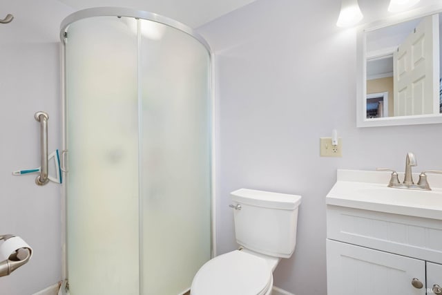 bathroom featuring vanity, toilet, and walk in shower