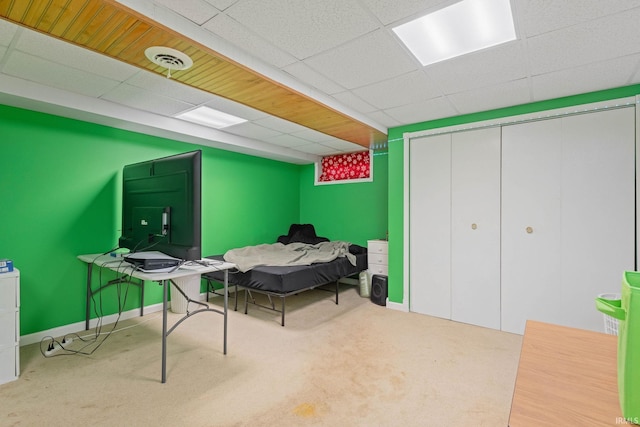 bedroom featuring a paneled ceiling and carpet floors