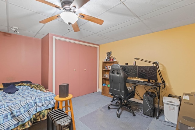 office space featuring ceiling fan and a drop ceiling