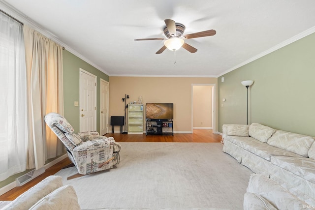 living room featuring crown molding, hardwood / wood-style floors, and ceiling fan