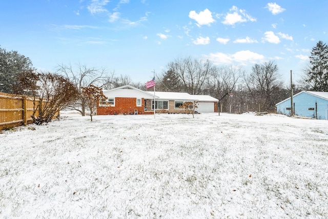 snow covered property with a garage