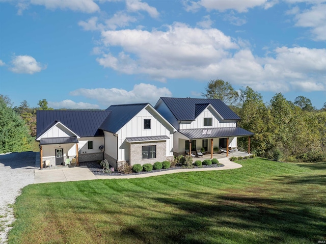 modern inspired farmhouse with covered porch and a front yard