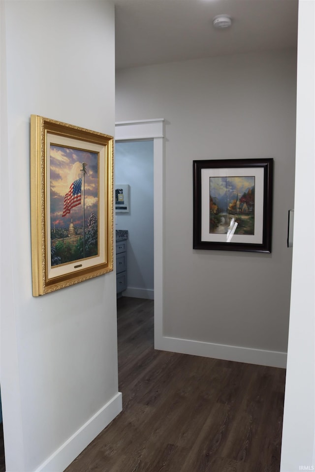 hallway with dark hardwood / wood-style floors