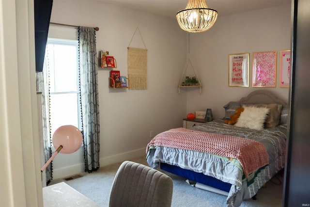 carpeted bedroom featuring a notable chandelier