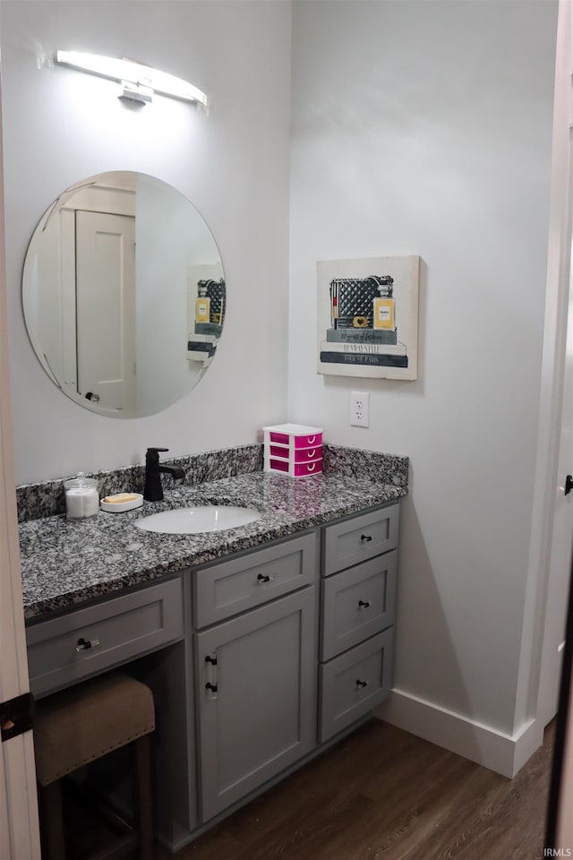 bathroom with hardwood / wood-style floors and vanity