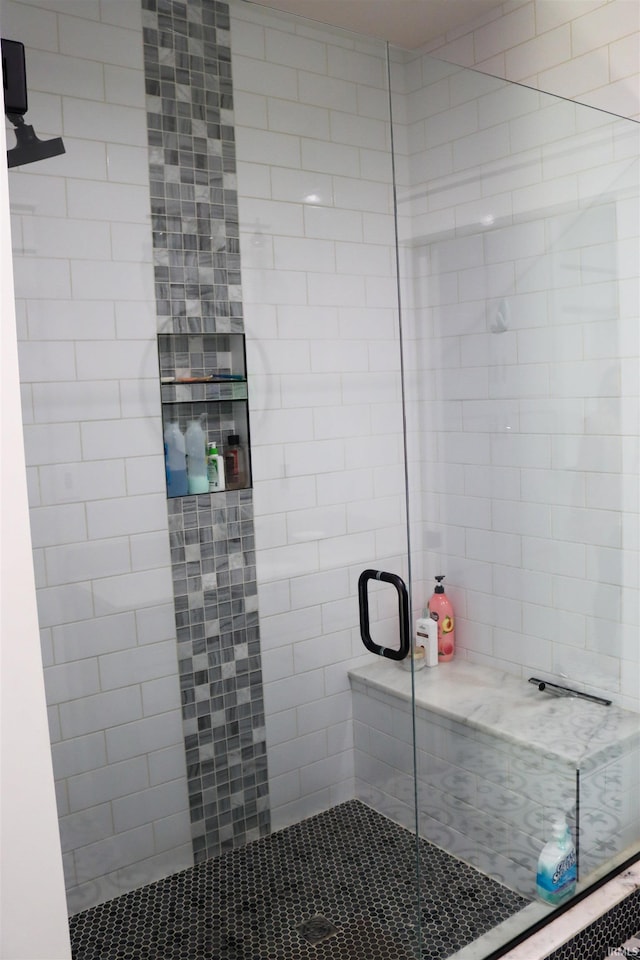 bathroom featuring a shower with shower door