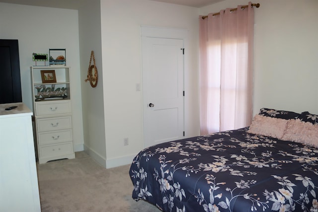 bedroom featuring light colored carpet