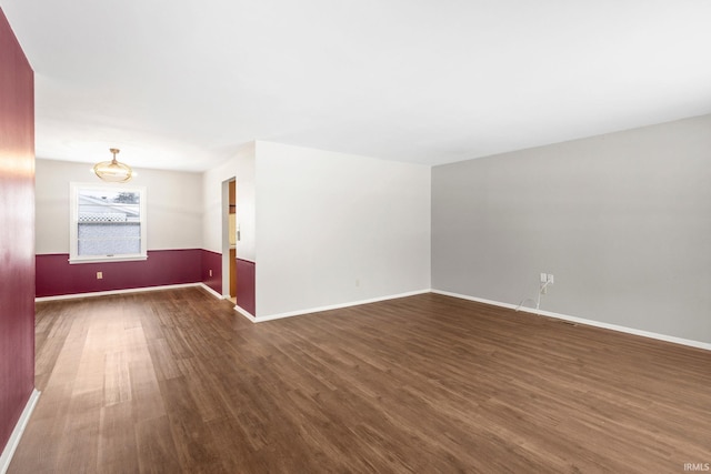 spare room with dark wood-type flooring