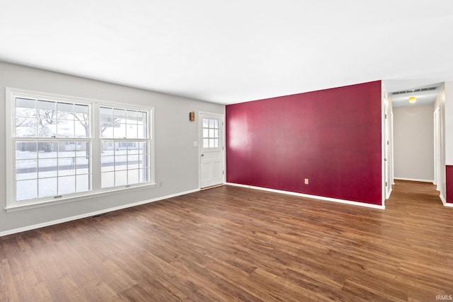 interior space with plenty of natural light and dark wood-type flooring