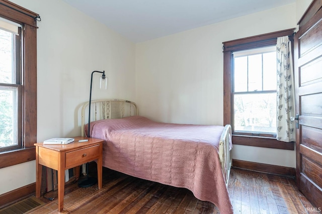 bedroom with dark wood-type flooring