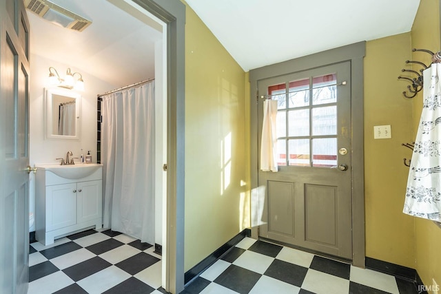 doorway with sink and lofted ceiling