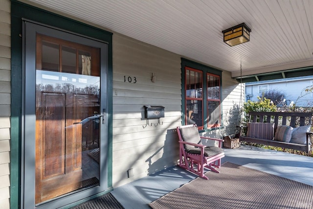 view of exterior entry featuring a porch