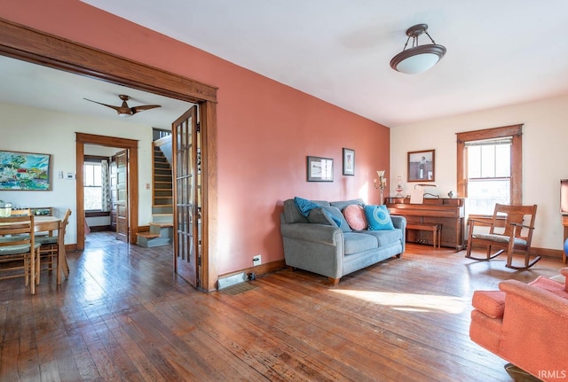 living room featuring hardwood / wood-style flooring and ceiling fan