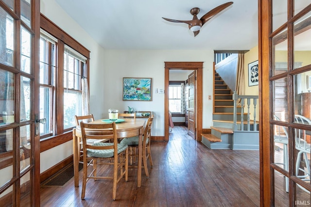 dining space with ceiling fan, dark wood-type flooring, and a wealth of natural light