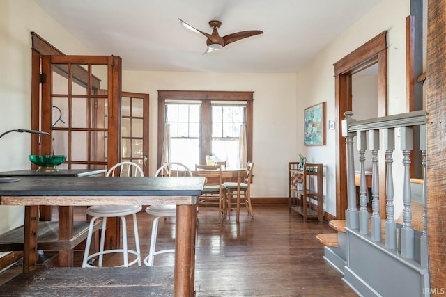 dining space with ceiling fan and dark wood-type flooring