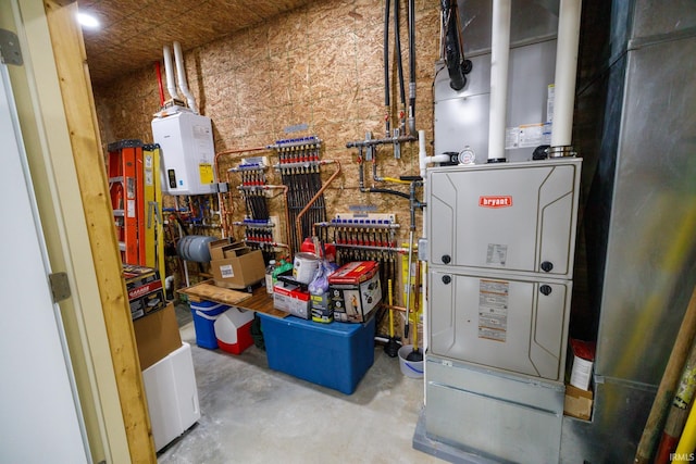 utility room featuring tankless water heater and heating unit