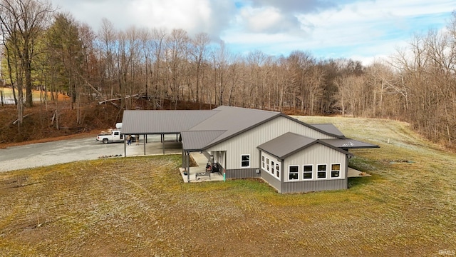 rear view of property with a yard and a carport