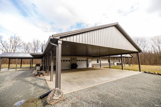 view of side of home featuring a garage and a carport