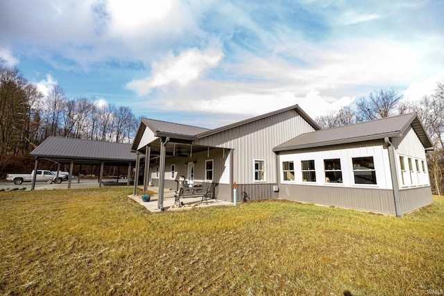 rear view of property with a patio and a lawn