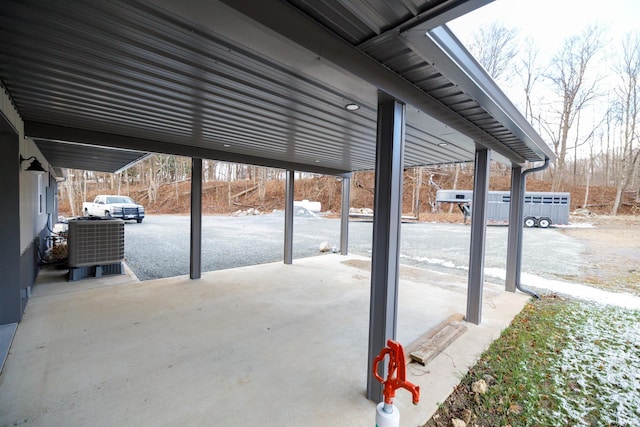 view of patio with central AC and a carport