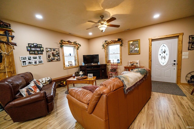 living room featuring ceiling fan and light wood-type flooring