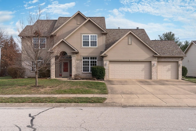 view of front of property with a garage and a front lawn