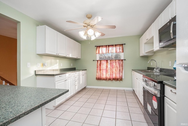 kitchen with stainless steel electric stove, white cabinets, sink, ceiling fan, and light tile patterned flooring