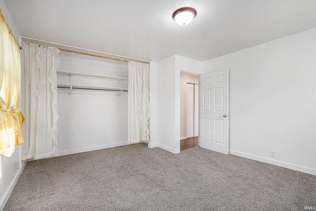 unfurnished bedroom with carpet and a closet