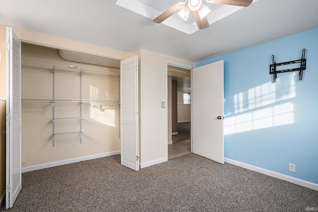 unfurnished bedroom with ceiling fan, a closet, and carpet floors