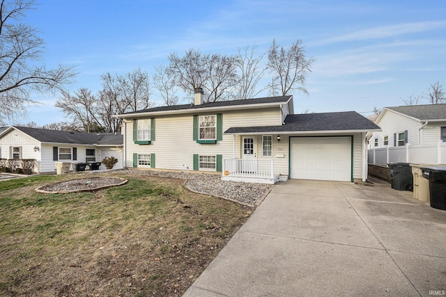 tri-level home featuring a front yard and a garage