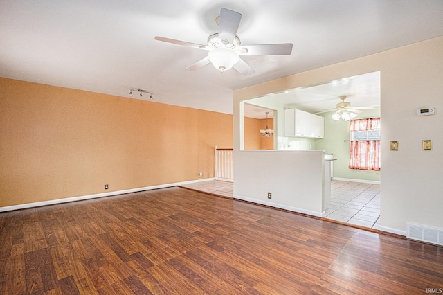 empty room featuring ceiling fan and light hardwood / wood-style floors