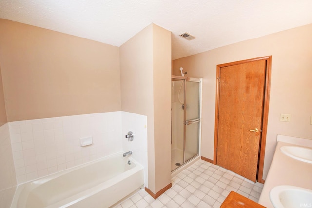 bathroom featuring shower with separate bathtub and sink