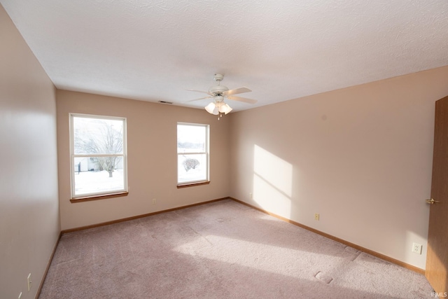 unfurnished room featuring light colored carpet and ceiling fan