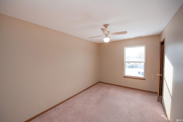 empty room featuring light carpet and ceiling fan