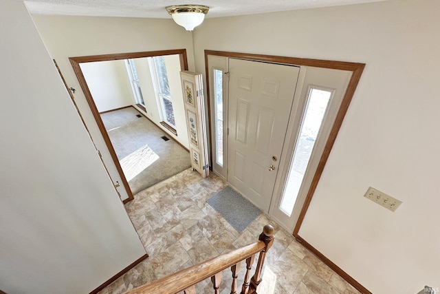 entrance foyer featuring lofted ceiling