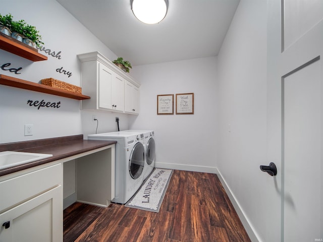 laundry area featuring cabinets, washer and dryer, dark wood-type flooring, and sink