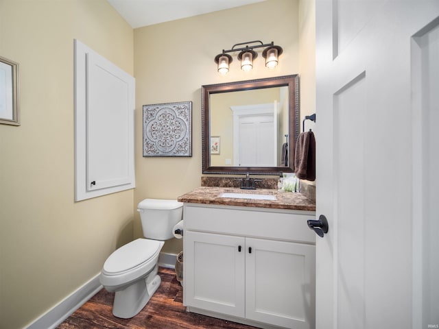 bathroom featuring hardwood / wood-style floors, vanity, and toilet