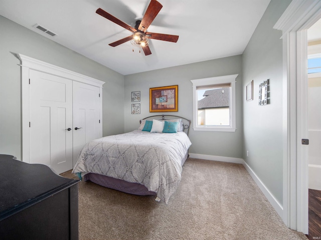 bedroom featuring multiple windows, carpet flooring, a closet, and ceiling fan